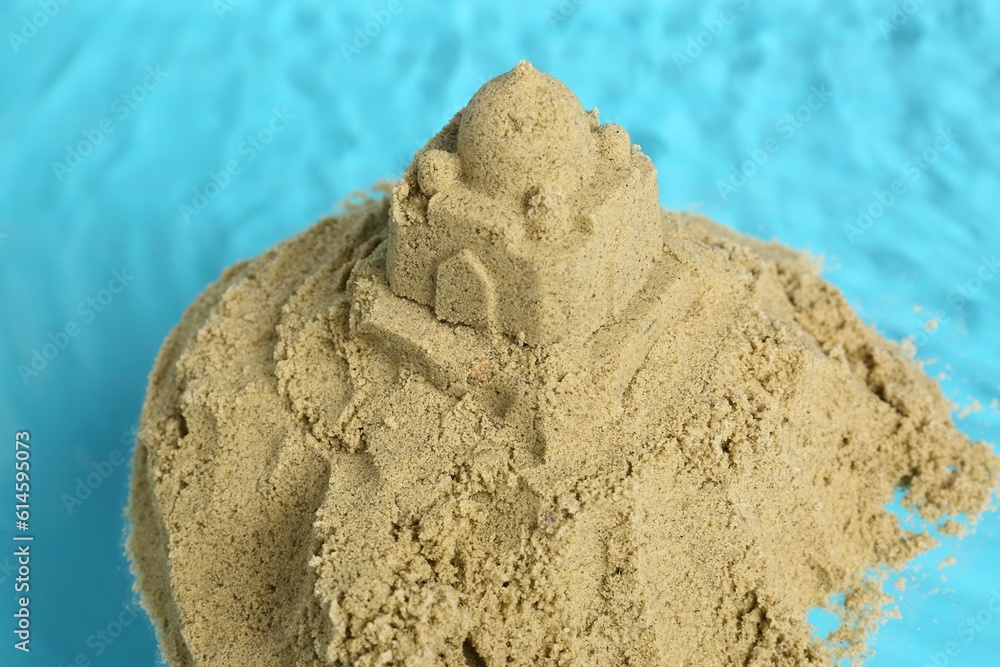 Pile of sand with sultan's palace on rippled water, closeup. Beautiful castle Pile of sand with sultan's palace on rippled water, closeup. Beautiful castle