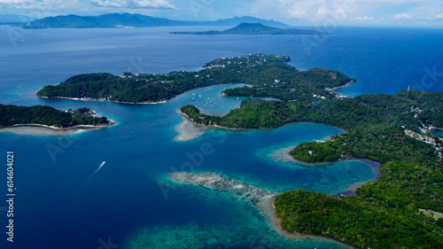 View of the sea and mountains. Tropical landscape. Aerial view of a tropical island. The coast of the island with small bays and straits. Boats are moving in the bay.