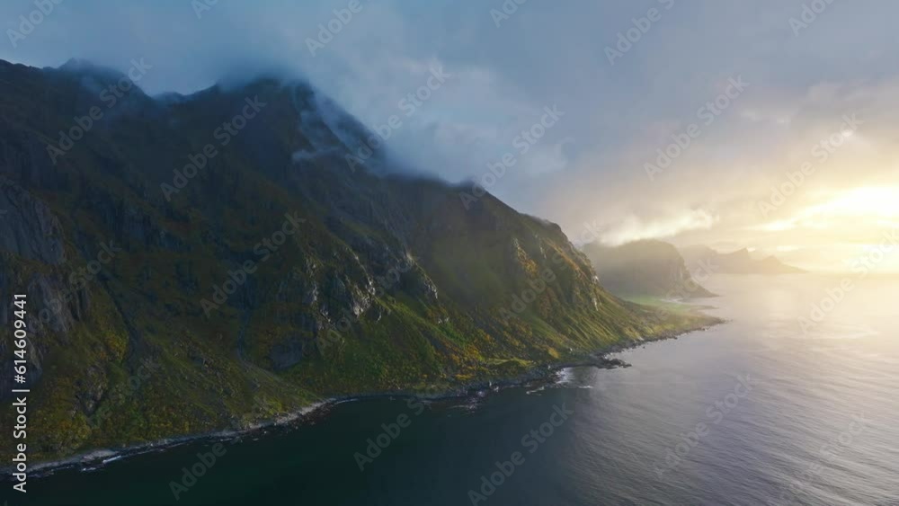 a Beautiful sunset with sunrays beaming on the mountainside of Tangstad Norway on the Lofoten islands a Beautiful sunset with sunrays beaming on the mountainside of Tangstad Norway on the Lofoten islands