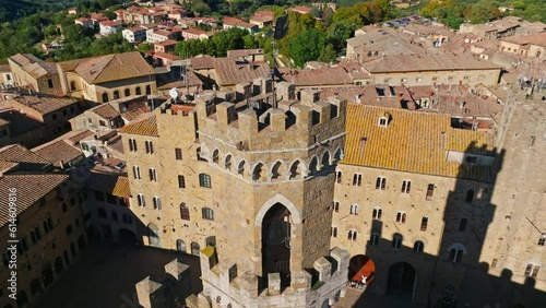 Aerial around one of the Towers of the Palace of the Priors, Palazzo dei Priori, Volterra, Province of Siena, Italy. Drone orbit shot photo