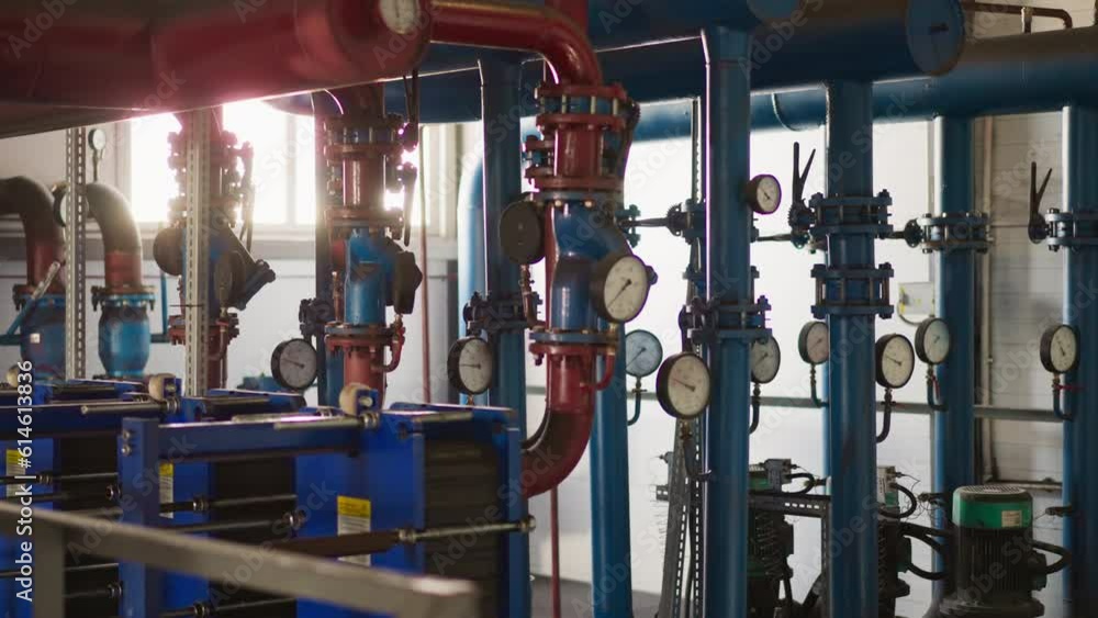 Complicated pipeline system and powerful pumps in boiler house. Heat producing equipment installed in modern building. Central heating utilities Complicated pipeline system and powerful pumps in boiler house. Heat producing equipment installed in modern building. Central heating utilities