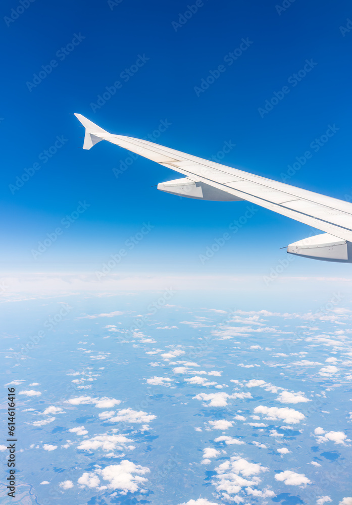 View from the airplane window at a beautiful cloudy sky and the airplane wing View from the airplane window at a beautiful cloudy sky and the airplane wing