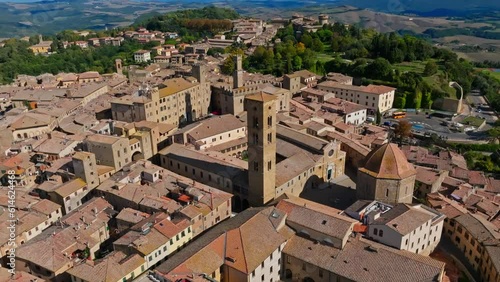 Aerial over town of Volterra and the Palace of the Priors, Palazzo dei Priori, Volterra, Province of Siena, Italy. Drone truck down shot photo