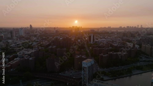 Drone shot over the sunlit Harlem skyline, dramatic evening in New York, USA photo