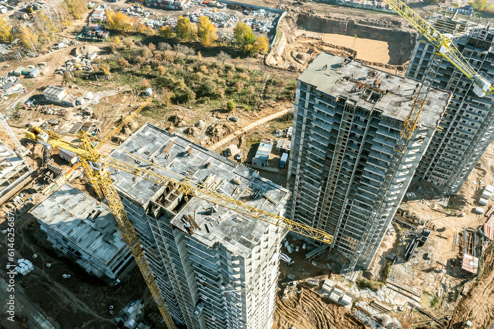 Obraz premium aerial view of a large construction site with buildings under construction and tower cranes.