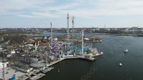 4K Aerial of Stockholm Historic City and Harbour . Stationery shot of Gröna Lund which is a theme park on the same Island as the Abba Museum. photo