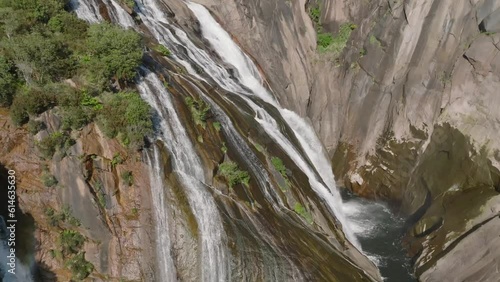 waterfall over rocks from aerial view photo