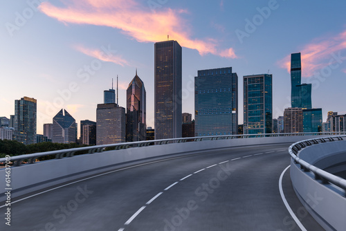 Empty urban asphalt road exterior with city buildings background. New modern highway concrete construction. Concept of way to success. Transportation logistic industry fast delivery. Chicago. USA.