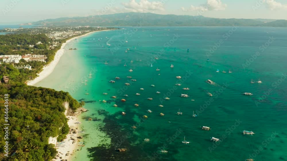 Aerial view of beautiful bay in tropical Island with white sand beach Boracay, Philippines. White beach with tourists and hotels. Tropical white beach with sailing boat. Aerial view of beautiful bay in tropical Island with white sand beach Boracay, Philippines. White beach with tourists and hotels. Tropical white beach with sailing boat.