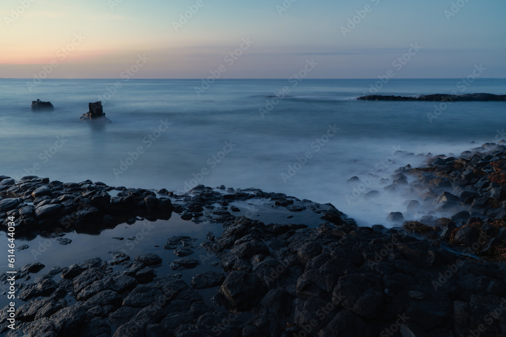 Photo exposes marine landscape in ancient lava rapids millions of years ago, at dusk of dawn. Seascape and geology concept. Soft focus.