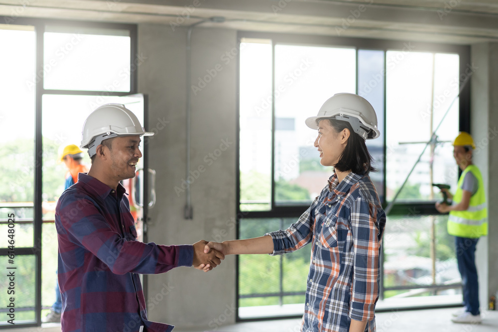 Successful deal, male architect shaking hands with client in construction site after confirm blueprint for renovate building. Successful deal, male architect shaking hands with client in construction site after confirm blueprint for renovate building.