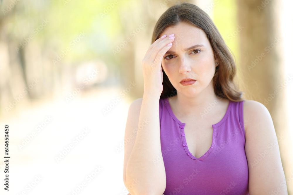 Worried woman complaining looking at camera
