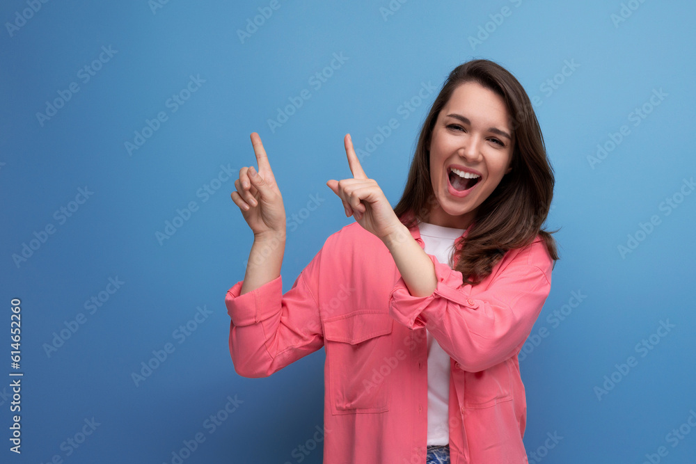 positive emotional black-haired woman in casual style announces discounts on studio background positive emotional black-haired woman in casual style announces discounts on studio background