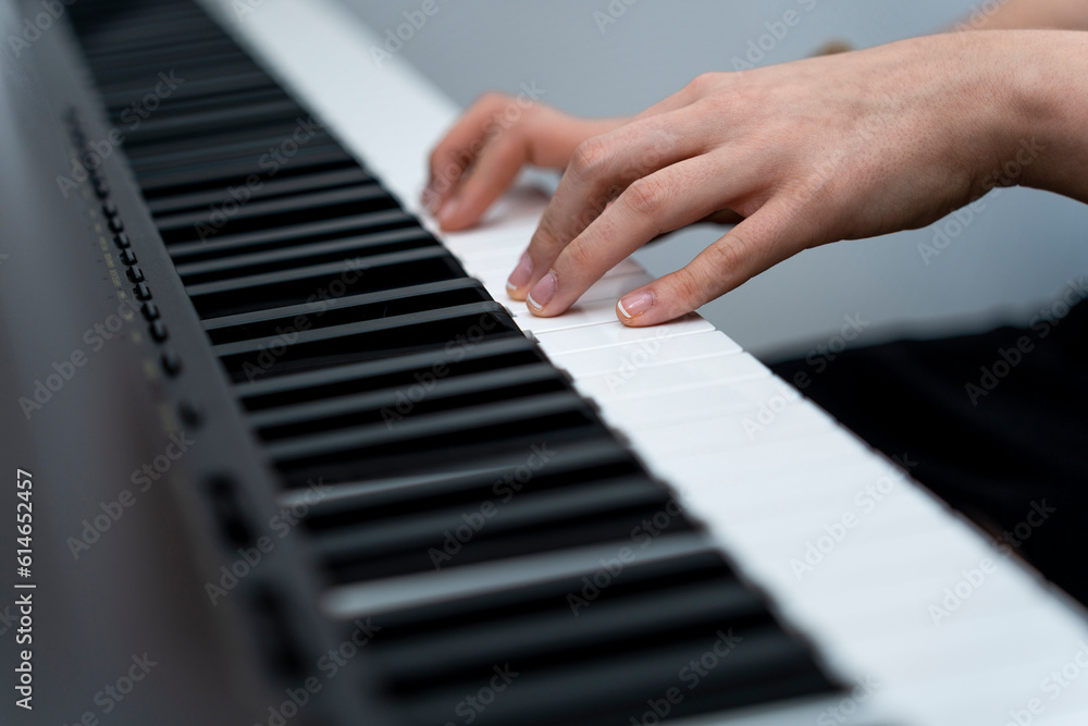 Obraz premium Graceful Pianist Creates Magical Melodies with Expert Fingertips