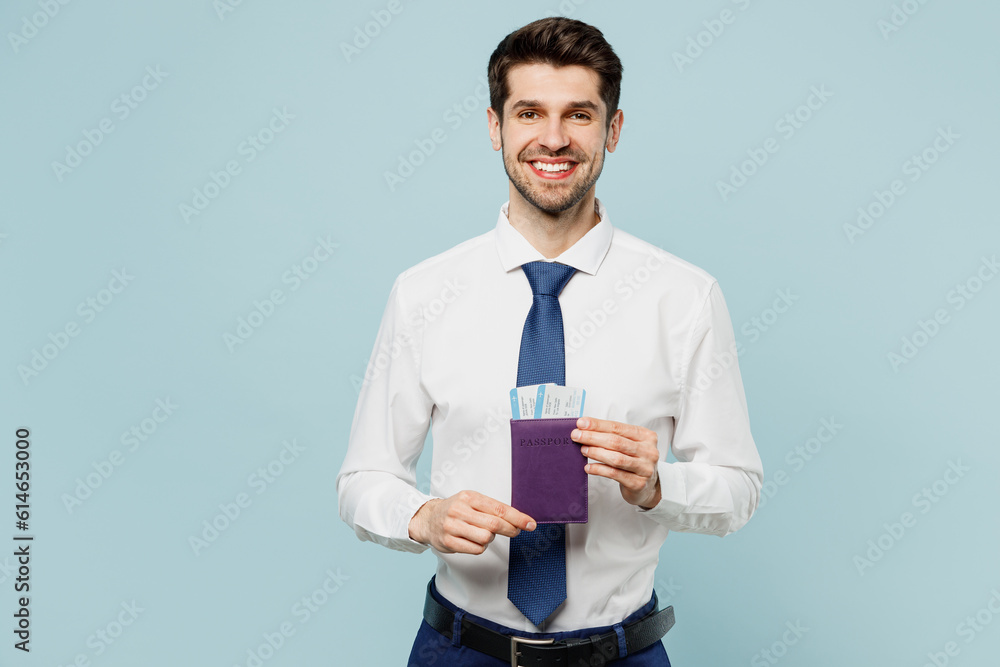 Traveler employee business man corporate lawyer wear shirt tie hold passport ticket isolated on plain blue background. Tourist travel abroad in free time rest getaway. Air flight trip journey concept. Traveler employee business man corporate lawyer wear shirt tie hold passport ticket isolated on plain blue background. Tourist travel abroad in free time rest getaway. Air flight trip journey concept.