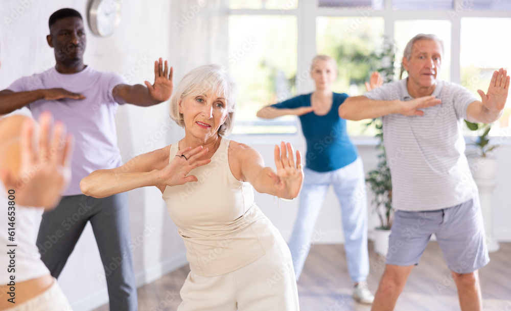 In fitness studio at group class, senior woman has fun and dances learn to move energetically to beat of music. Modern dance school, active lifestyle