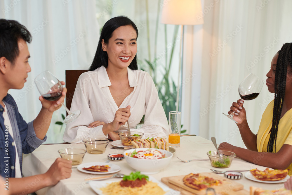 Happy woman hosting birthday party at home