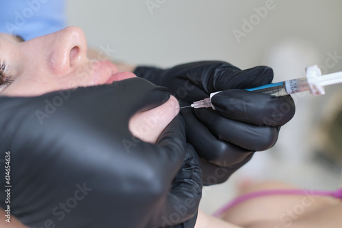 chin injection using hyaluronic acid, providing a glimpse into the precision required in such procedures. Cosmetology Education: Teaching students about practical applications of facial injections.