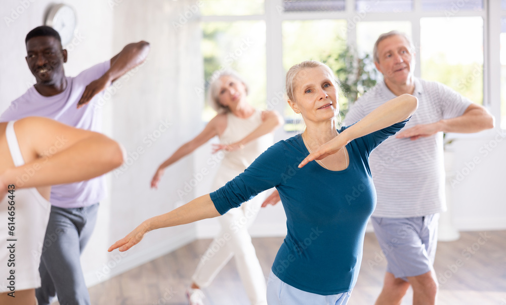 Senior woman and friends people dancing in studio or gym doing sports or practicing dance number. Physical activity, good bodily shape