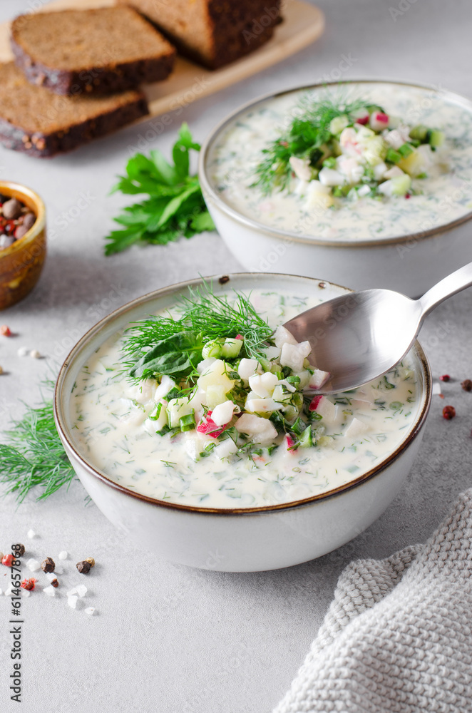 Cold Okroshka Soup with Eggs, Vegetables, Meat, Herbs and Kefir on a Bright Background, Summer Soup Cold Okroshka Soup with Eggs, Vegetables, Meat, Herbs and Kefir on a Bright Background, Summer Soup