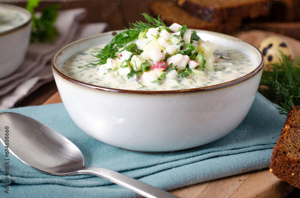 Cold Okroshka Soup with Eggs, Vegetables, Meat, Herbs and Kefir on a Wooden Background, Summer Soup Cold Okroshka Soup with Eggs, Vegetables, Meat, Herbs and Kefir on a Wooden Background, Summer Soup