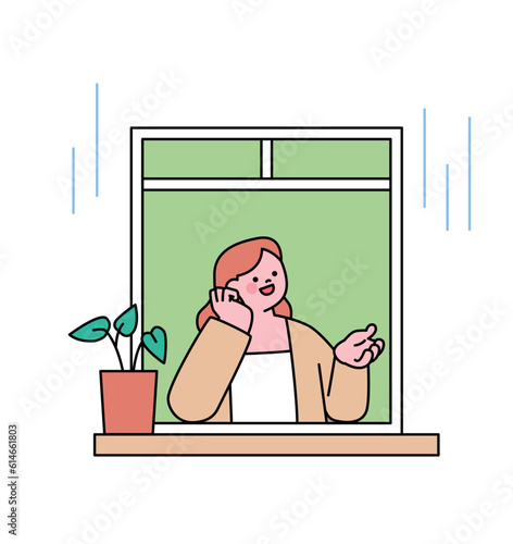 Rainy day. A woman is admiring the rain with one hand out the window. Simple flat design style illustration with outlines.