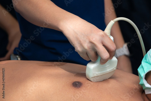 doctor use an ultrasound to examine the patient's body to find out the cause of the illness. extended focused assessment with sonography in trauma 
