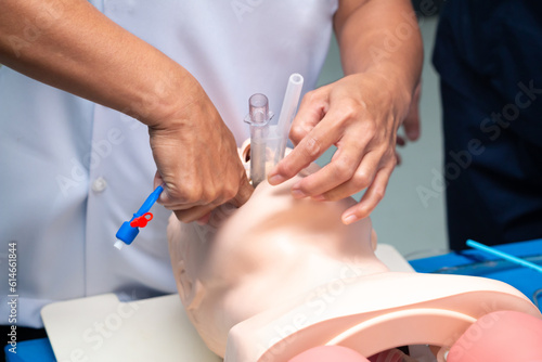 Anesthesiologist performing an orotracheal intubation on a simulation, Medical manipulation. mannequin dummy during medical training to control of the airway.