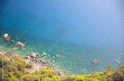 stone in turquoise water , Blue sea
