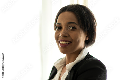 Portrait of smiling successful happy relax profile attractive confident black african creative business woman, fashionable, model, creative female look at camara enjoying standing at office