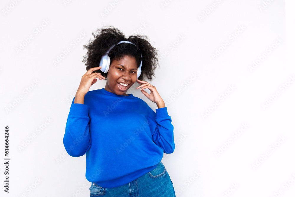 Afro woman enjoying music with headphones against white background Afro woman enjoying music with headphones against white background