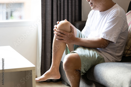 Asian middle aged man suffer from Arthritis,Patellar Tendinitis,symptom of Gout,deposition of chalkstones,painful inflammation and stiffness of the joints,ligament injuries,feel tingling pain in knee photo