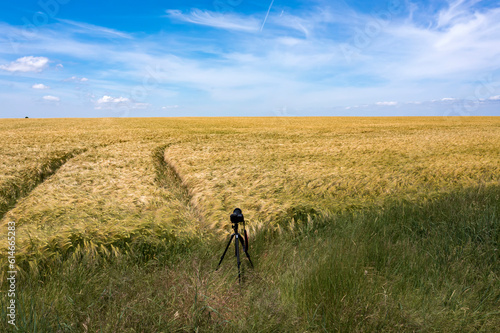 A camera on a tripod shooting landscape