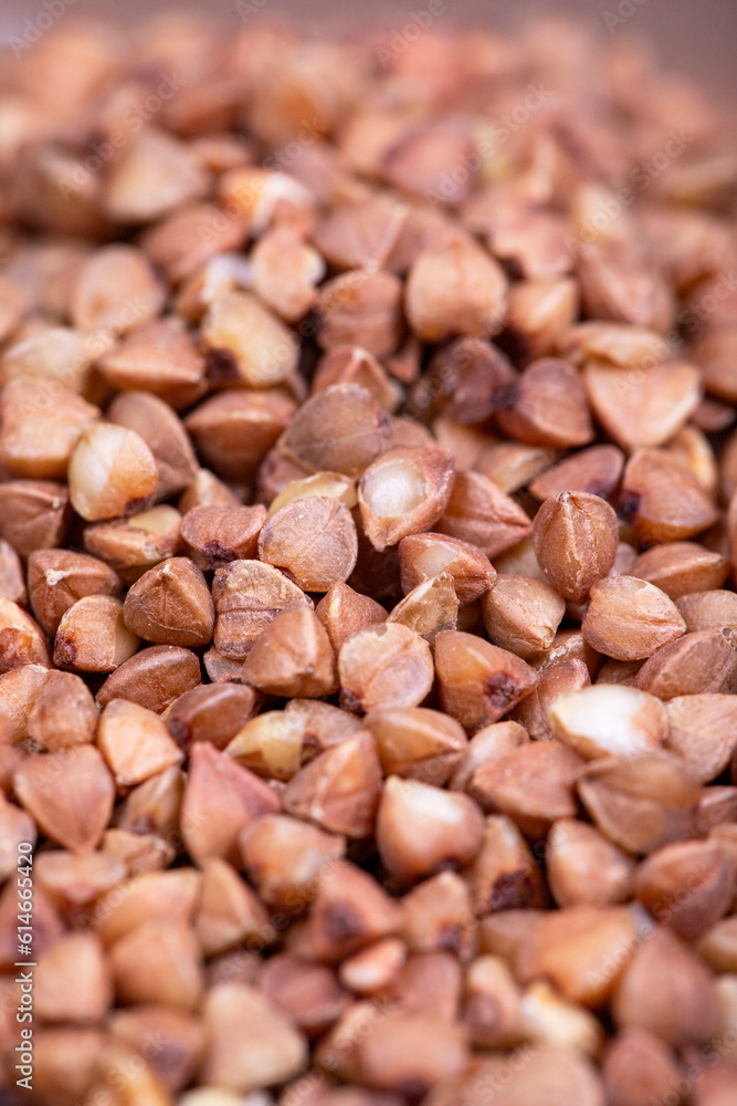 Fototapeta premium Pile of buckwheat grains as background, spice or seasoning as background. close-up buckwheat