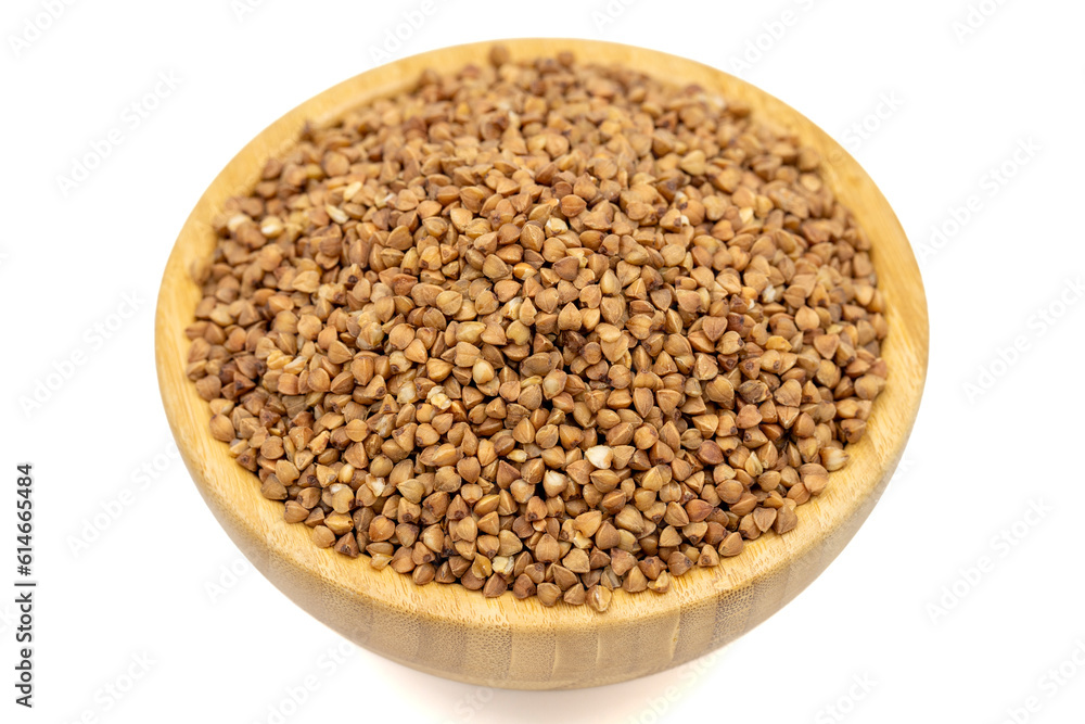 Buckwheat isolated on white background. Buckwheat grains in wooden bowl. Close up Buckwheat isolated on white background. Buckwheat grains in wooden bowl. Close up