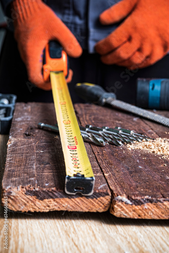 Measuring tape on a wooden board. The concept of measuring length..