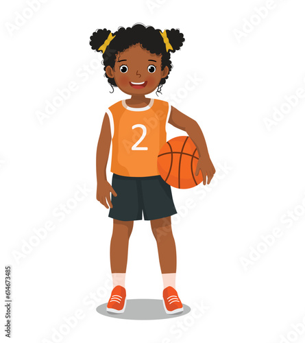 Cute little African girl with sportswear posing holding basketball 
