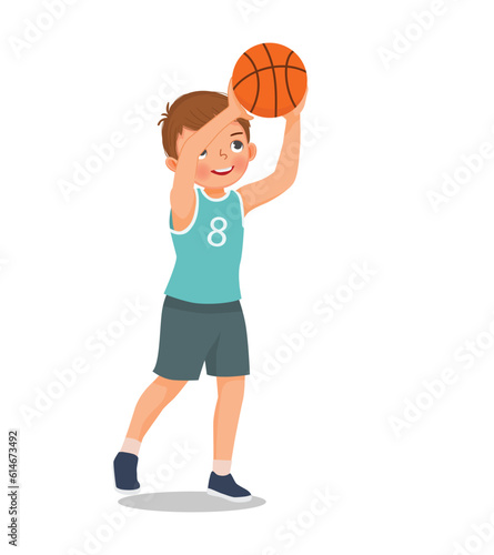 Cute little boy ready to shoot basketball at the rim