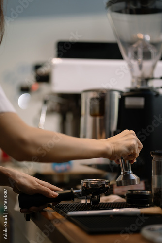 Young barista making coffee  coffee preparation service concept.