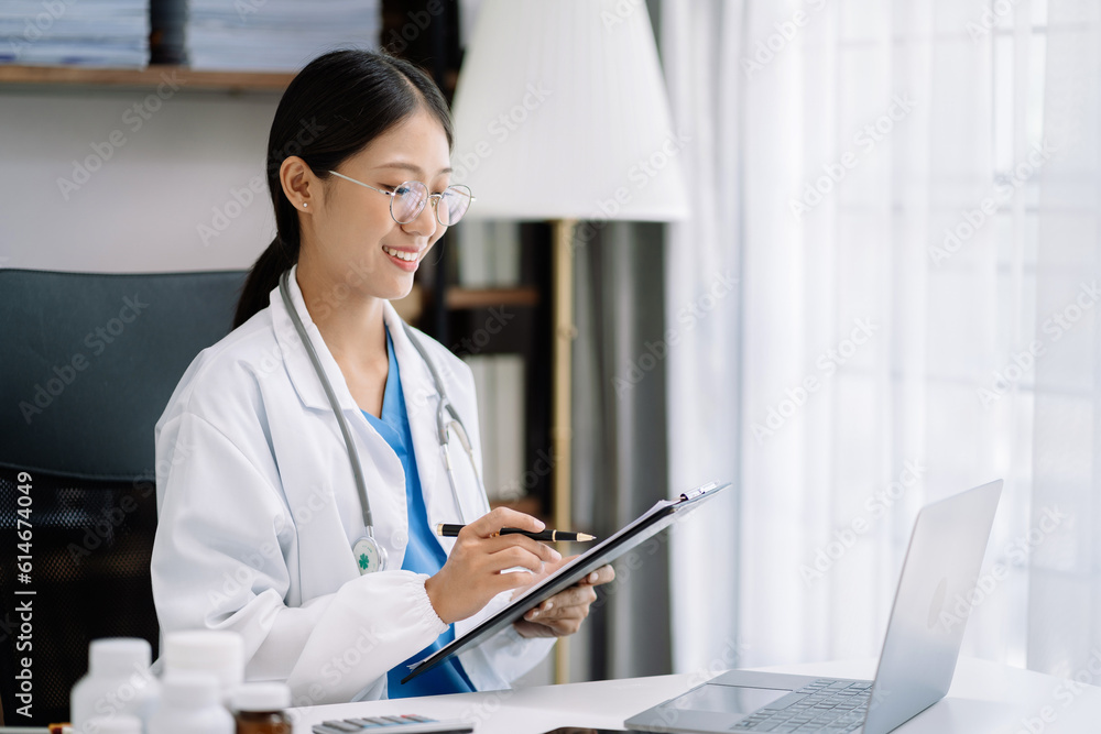 female medical doctor's hands write a note and use tablet working. Doctor's working place. Healthcare and medical concept. female medical doctor's hands write a note and use tablet working. Doctor's working place. Healthcare and medical concept.