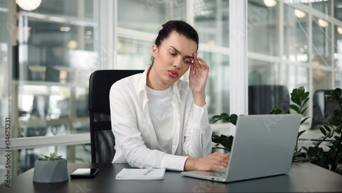 Tired young latin spanish woman office worker take short pause in online work massage nose bridge relax with closed eyes. Female employee overworked by pc feel fatigue suffer from eye strain headache.