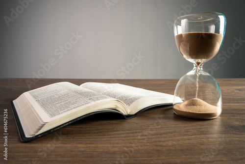 Hourglass and open book