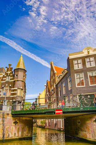 Amsterdam, Netherlands - Cityscape with tourists and local people in historical downtown.