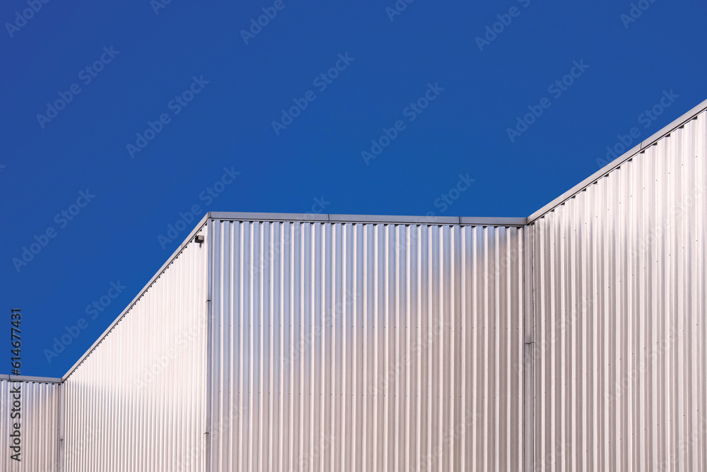 Aluminum Corrugated Industrial Building against blue clear sky Background in low angle and Perspective side view