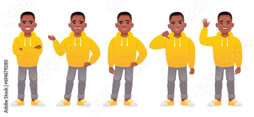 Black little boy stands with his arms crossed, pointing at something, waving his hand, showing a dislike sign. Cute African schoolboy
