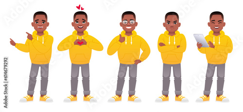 Black little boy stands with a tablet in his hands, in love, points to something, shows like, dissatisfied with something.