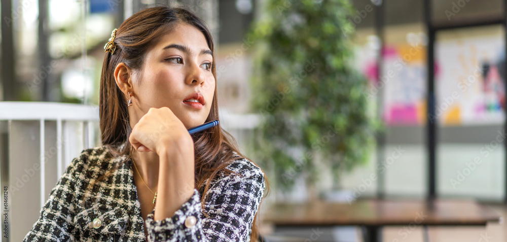 Portrait of smiling happy beautiful woman relax sitting on chair.Young hipster creative girl freelancer business thinking with new idea content in cafe