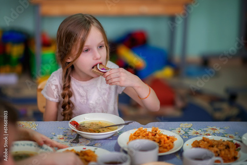 Kindergarten. Junior School. Lunch at the little schoolchildren. Little schoolchildren. Kindergarteners. Children. Friends. Studies. Food in the dining room. Soup. Fried cabbage. The children are havi