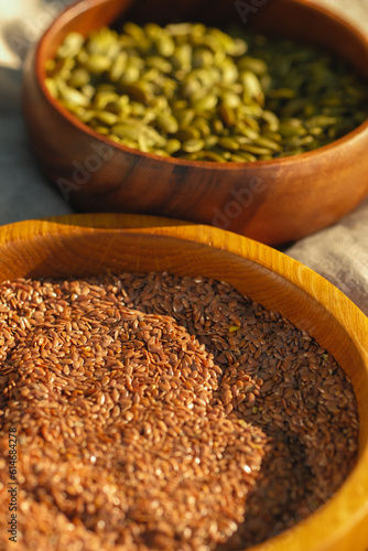 two wodden bowls with pumplin seeds and milk thistle photo