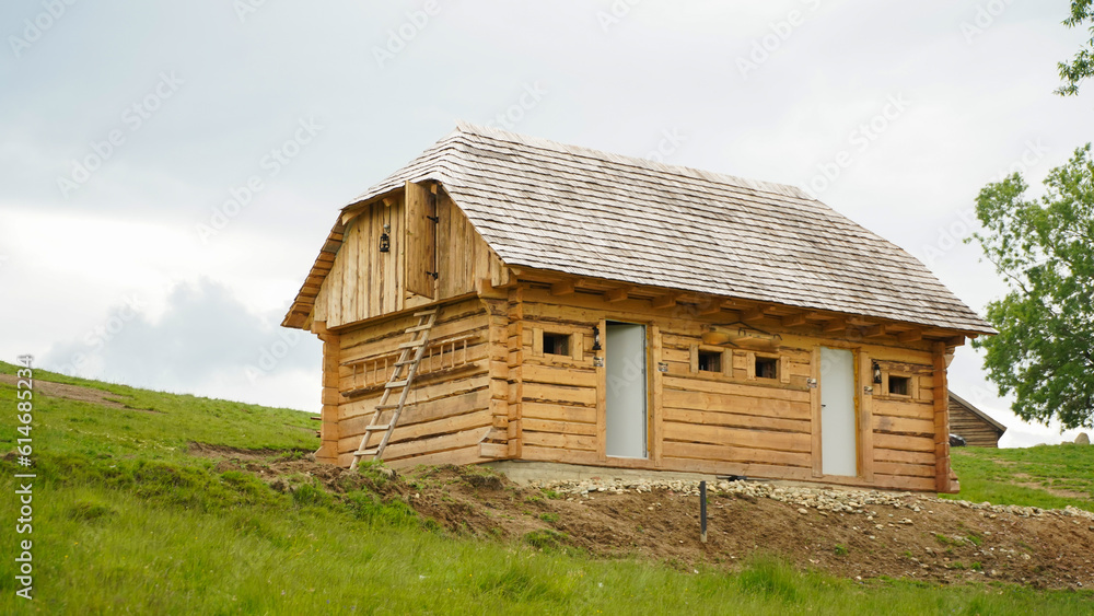 wooden cabin in a mountain area. landscape.